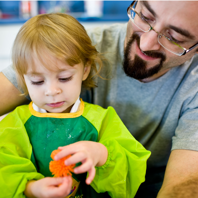 Dad with child doing activity together during Starting Right class