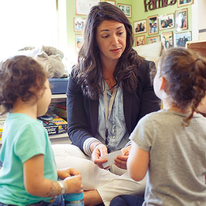 Employed NSU education student doing classroom activity with children