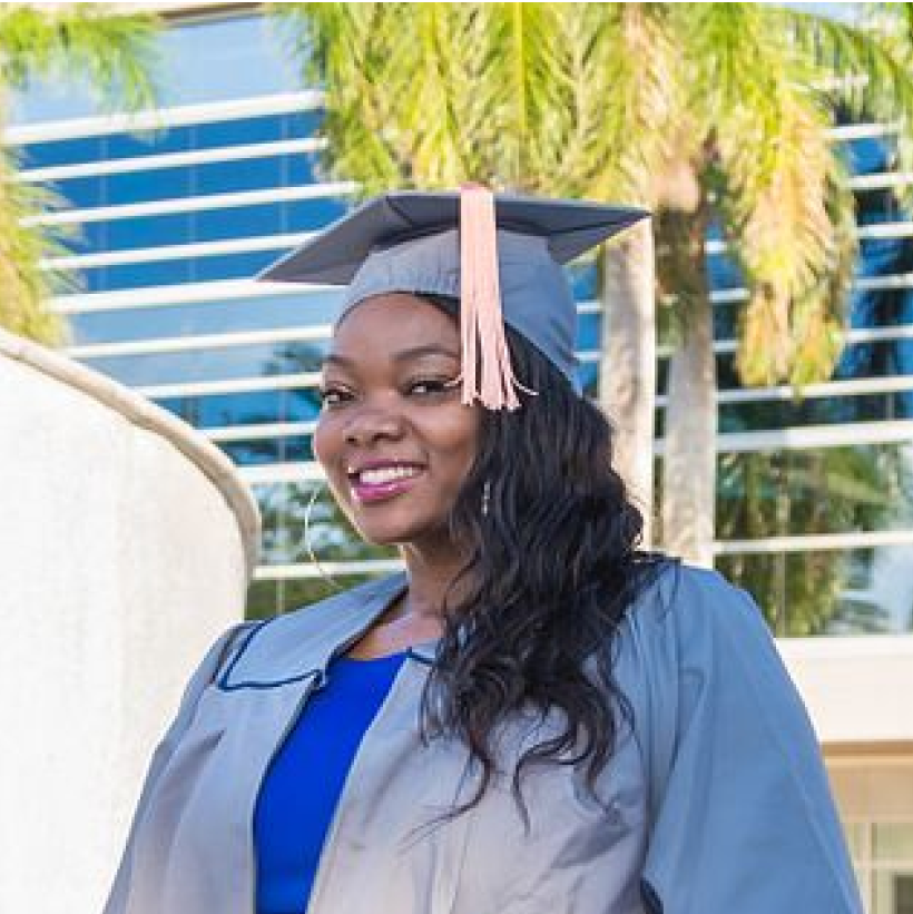 NSU graduate smiling in cap and gown