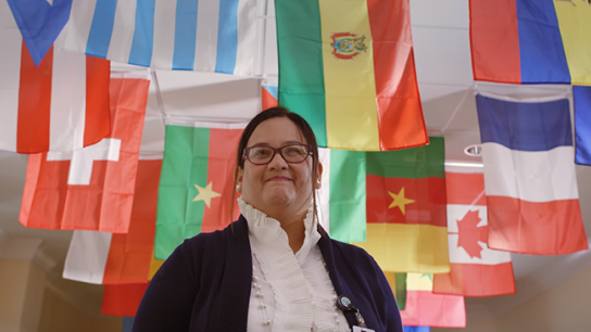 Close-up of woman with a backdrop of international flags