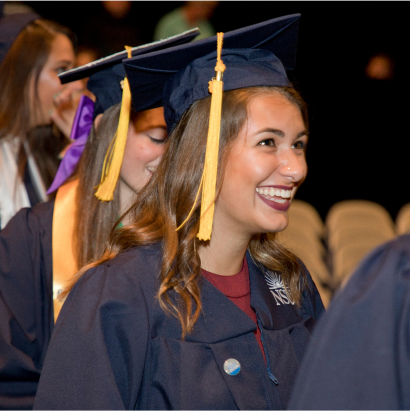 NSU Graduate in cap and gown smiling