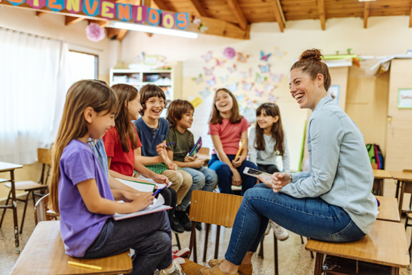 latin female educator teaching spanish to young kids